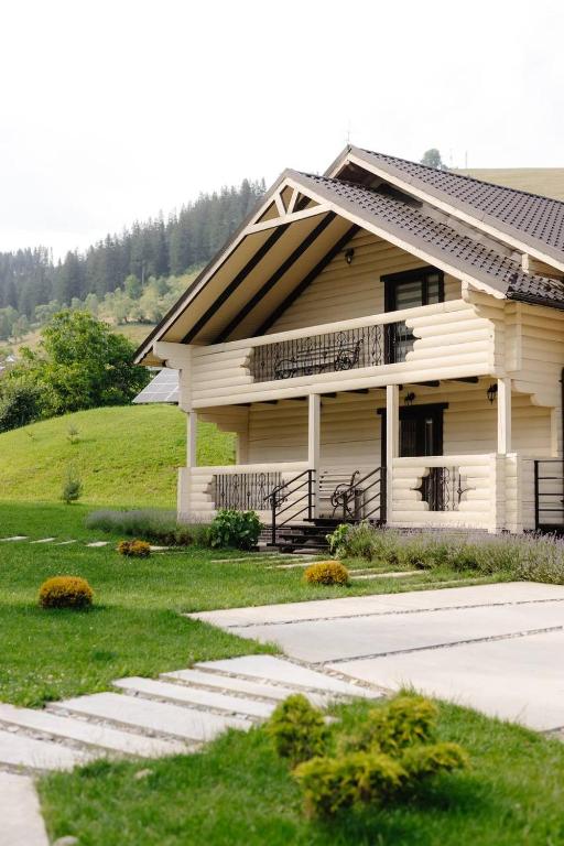 KrasnikВілла у горах的白色的房子,前面有楼梯
