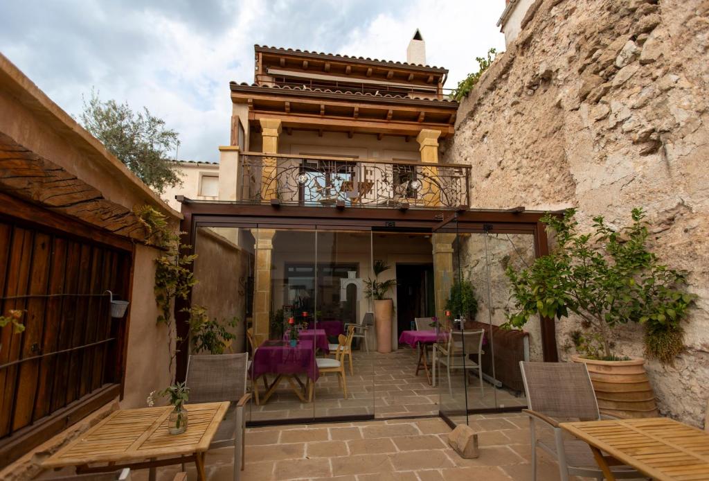 塞古拉 - 德拉谢拉Hotel Poeta Jorge Manrique的一个带桌椅的庭院和一个阳台