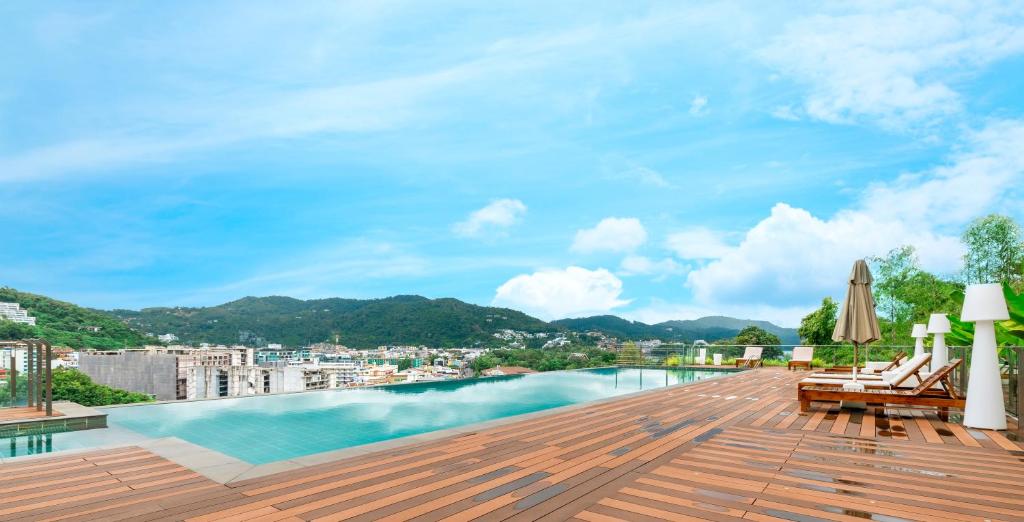 卡塔海滩Rudi Condo by Q Conzept的从带游泳池的建筑屋顶上欣赏美景