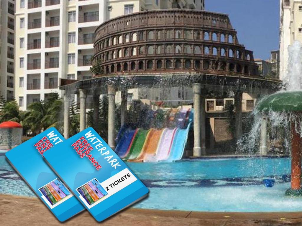 马六甲STUDIO ROOM at BAYOULAGOON RESORT, MELAKA的两本书坐在一个带塔的喷泉旁