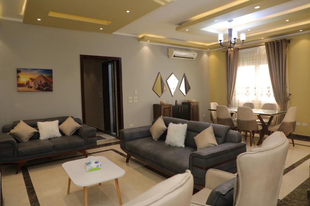 开罗Luxurious apartment - New Cairo的带沙发的客厅和用餐室