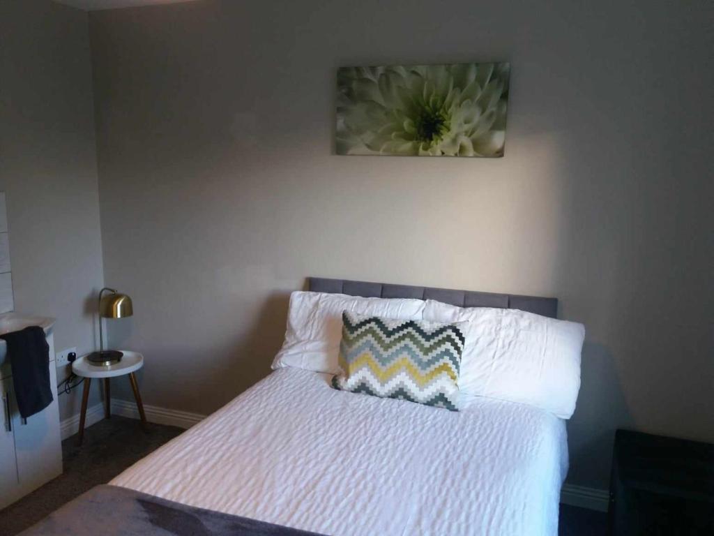 卡里格莱恩Dún Eoin Carrigaline的卧室配有一张挂着鲜花的床