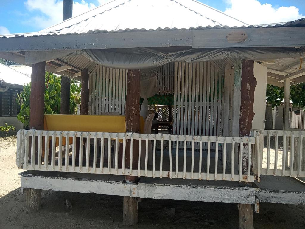 ManaseVacation beach fale的一个带屋顶门廊的小房子