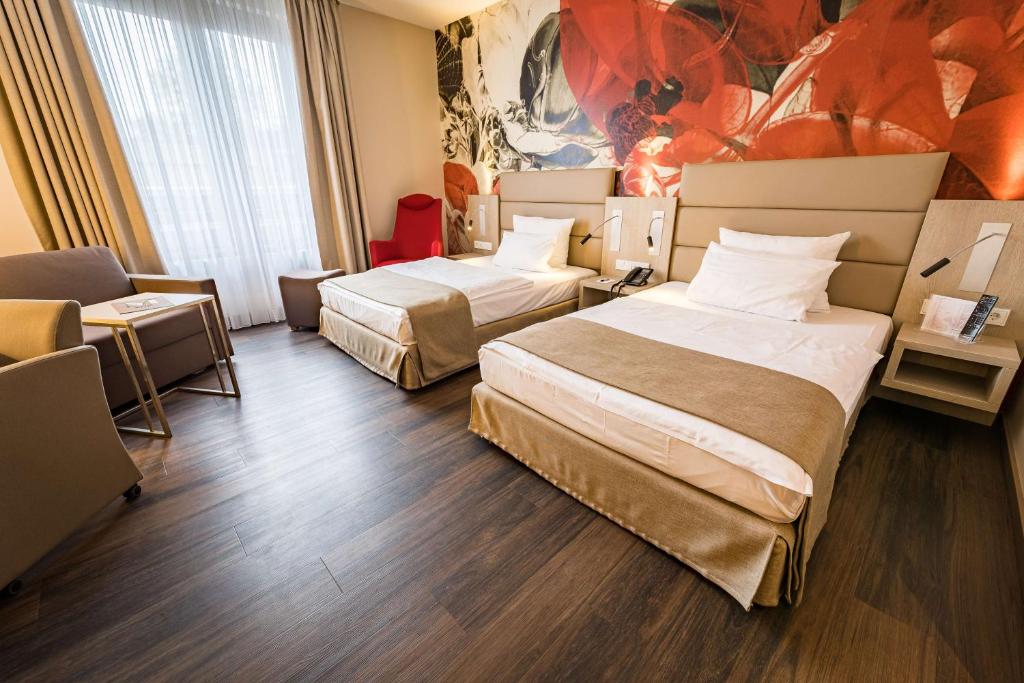 茨维考茨维考第一酒店的酒店客房,设有两张床和一张沙发