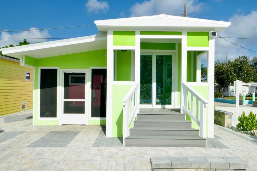 萨拉索塔Key Lime Tiny Home New&Cozy的一座带门廊的绿色白色小房子