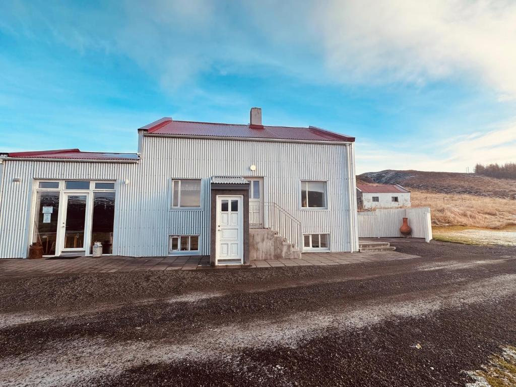 ÞingeyjarsveitOriginal North的土路上的白色建筑,有门