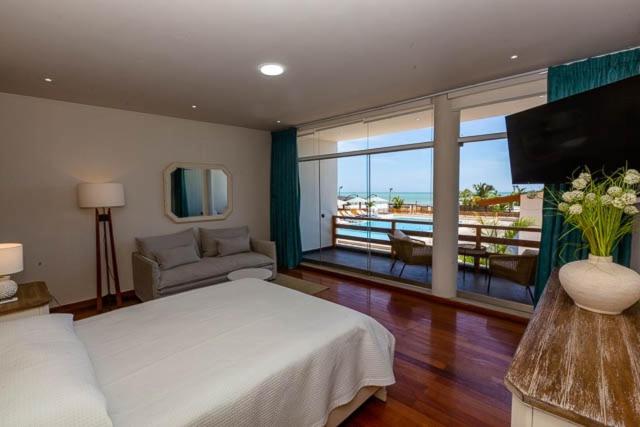 索里托斯Hotel Boutique Caleta Grau的一间带一张白色大床的卧室和一个阳台