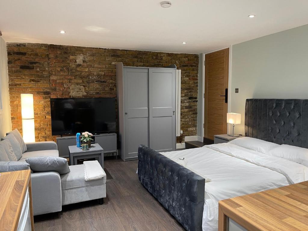 伦敦Cosy Studio Flat with Balcony in Heart of London的一间带大床的卧室和一间客厅