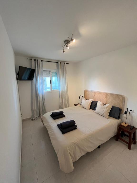 贝尼卡西姆APTO RESIDENCIAL EN BENICASIM的一间卧室配有一张大床和两个枕头