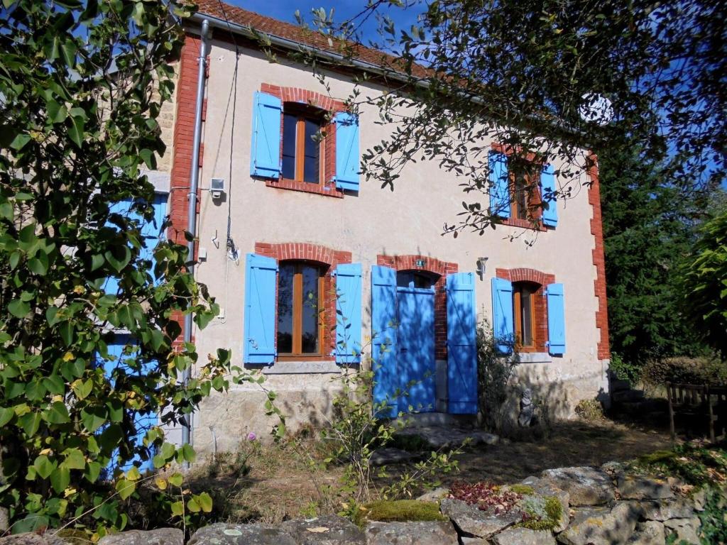 Saint-Julien-la-GenèteHoliday home in Saint-Julien-La-Genête的一座带蓝色百叶窗的老房子