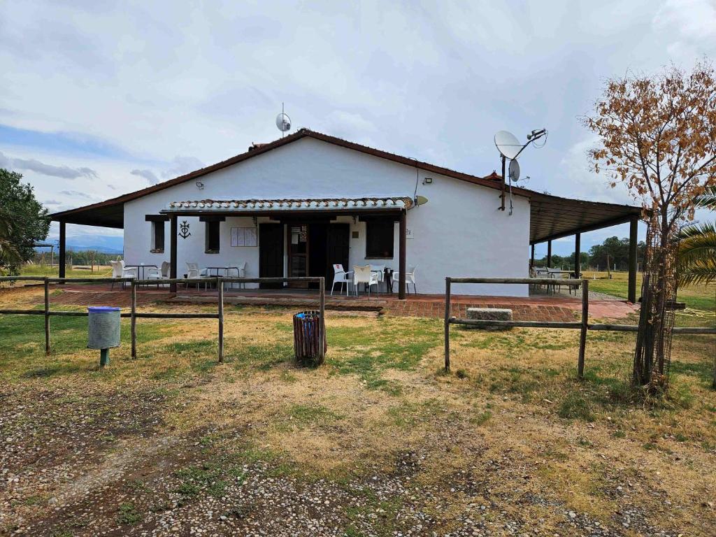TorilHotel Rural Portilla de Monfragüe的一座白色的小房子,配有卫星