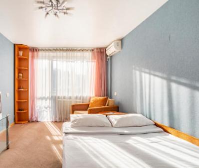 基辅Apartment with a panoramic view of Podil near the metro的一间卧室设有一张大床和一个窗户。