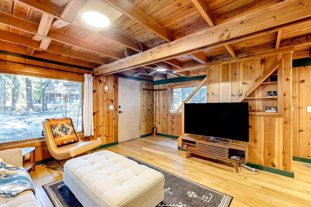 加文门特营The Cozy Govy Cabin的一间客厅,位于一间小屋内,配有平面电视。