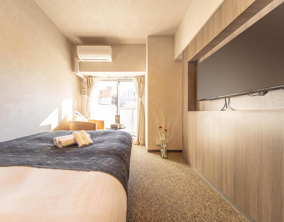 大阪住一心斋桥2号店的一间卧室配有一张床和一台平面电视