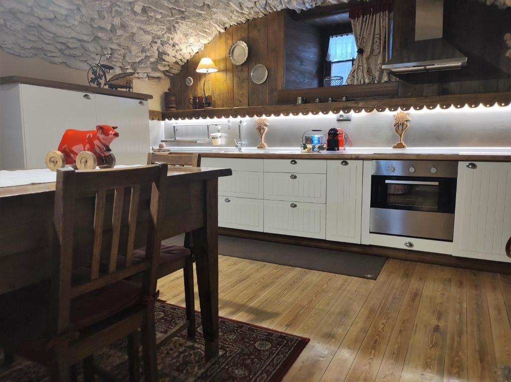 圣皮埃尔Le Petit Château de Vetan CIR 0023的厨房配有白色橱柜、桌子和炉灶。