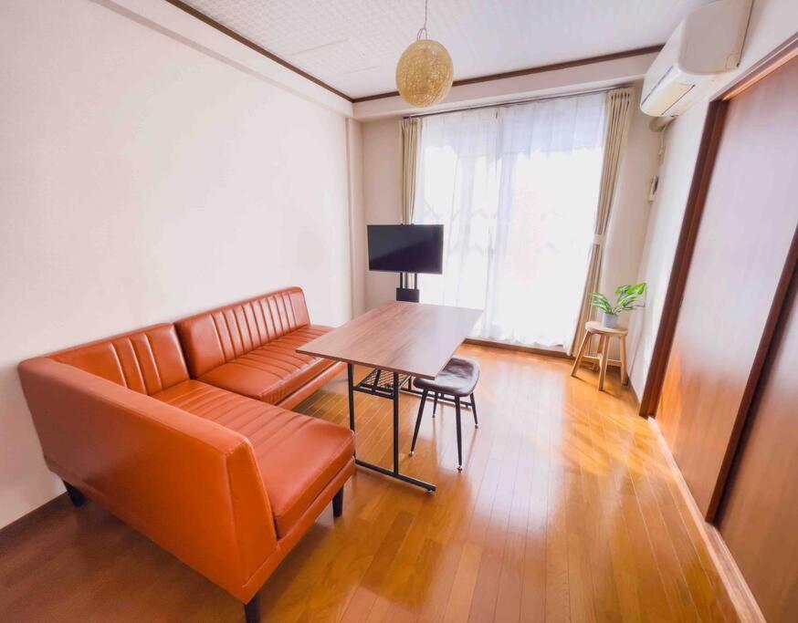 东京Maison Yachiyo 43m2 1 bedroom apartment的客厅配有沙发和桌子