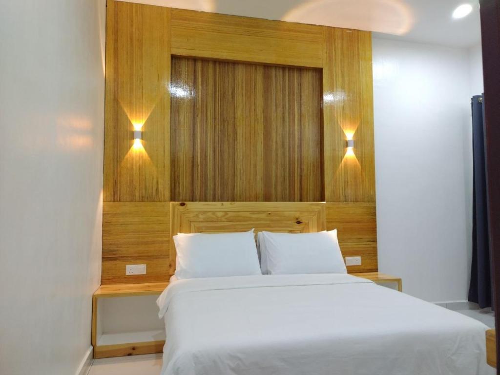 珍南海滩FUNDUQ AL BUSYRA的卧室配有白色的床和2个枕头