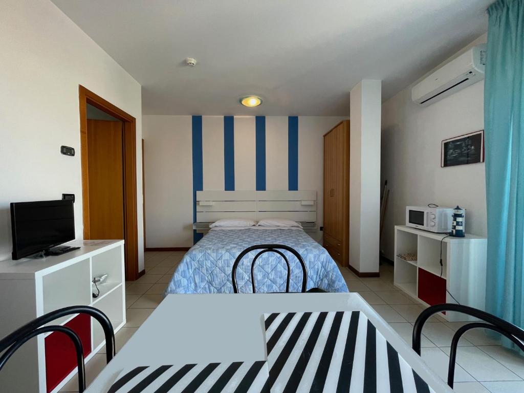 里米尼阿苏拉住宅别墅的一间带床和电视的小卧室
