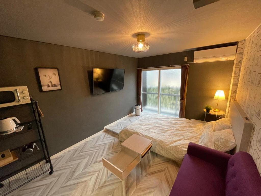 雾岛市InnCocoSumu？ - Vacation STAY 02654v的酒店客房设有床和窗户。