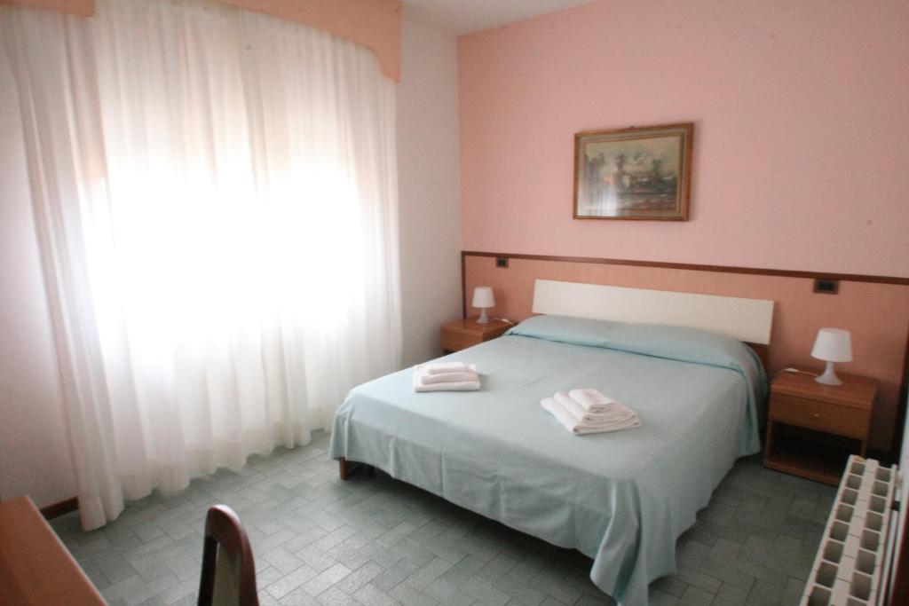 蒙特卡蒂尼泰尔梅雷迪酒店 的一间卧室配有一张床,上面有两条毛巾