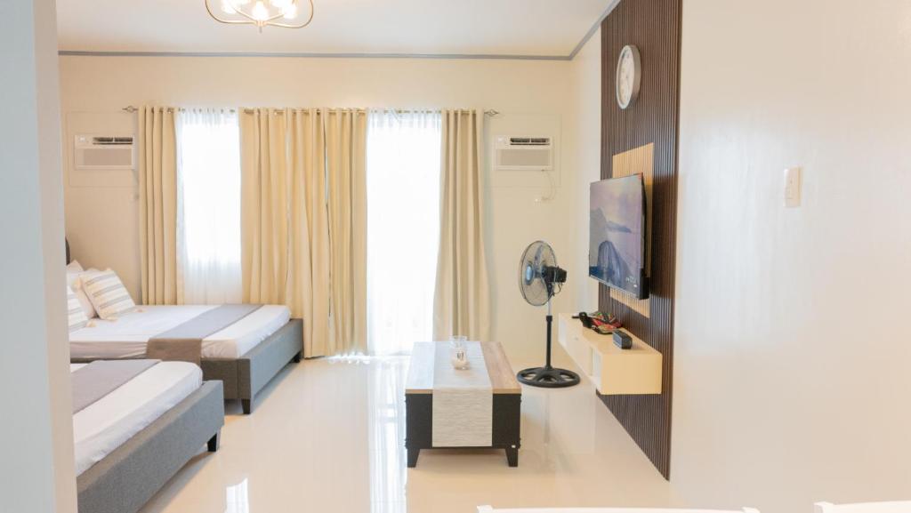 公主港Palawan Twin-Bed Paradise with a Balcony plus FREE Pool, Gym & Parking-7Kunzite的一间卧室配有一张床、一张桌子和一台电视。