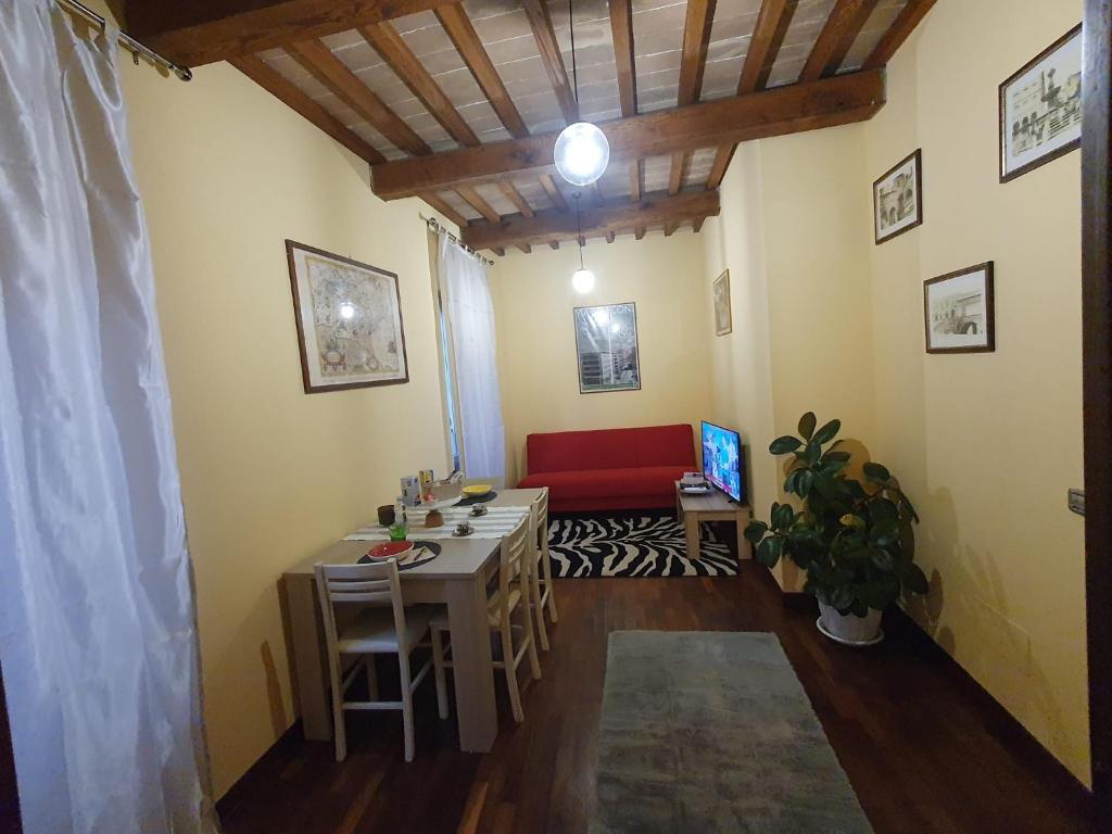 维泰博la Suite del Suffragio的客厅配有桌子和红色沙发