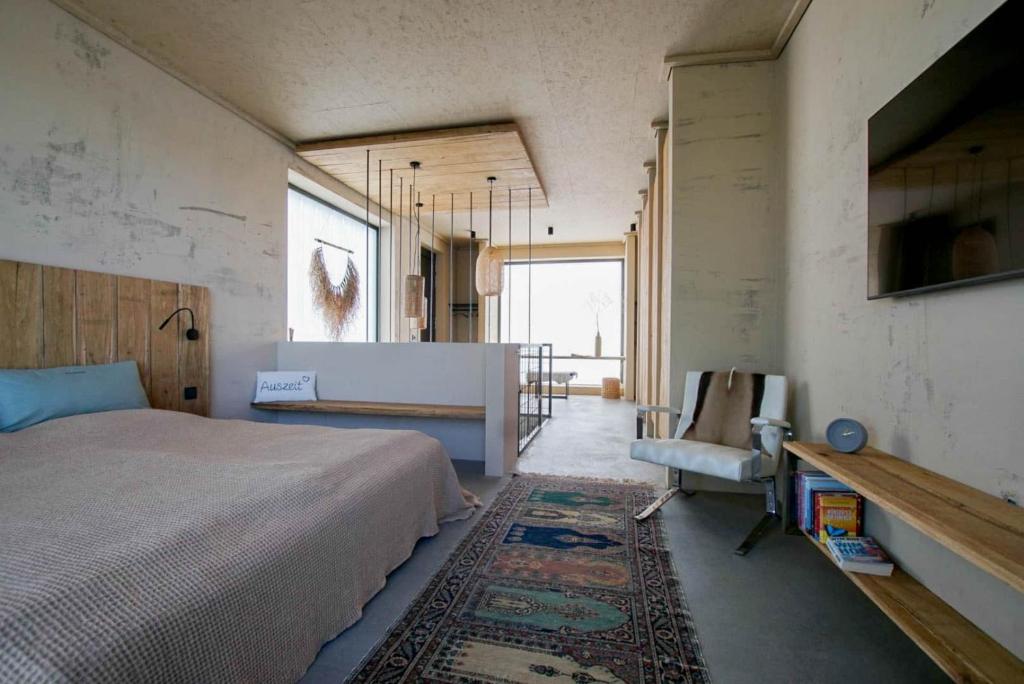 诺德豪森Ferienhaus am See的卧室配有1张床、1张桌子和1把椅子