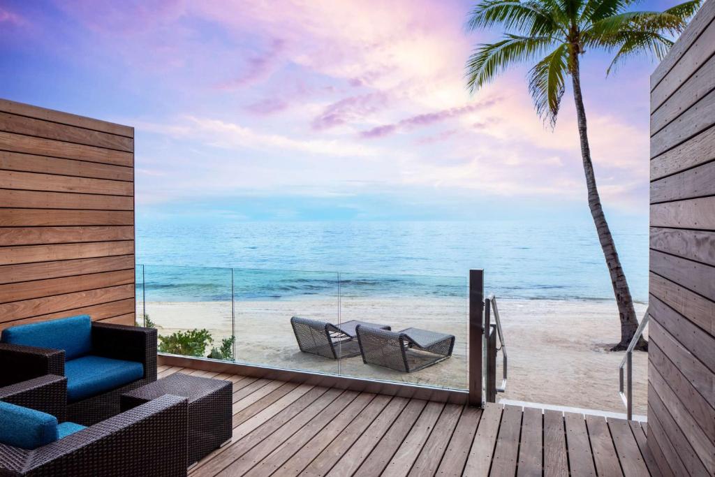 基韦斯特Casa Marina Key West, Curio Collection by Hilton的一个带两把椅子的甲板,享有海滩美景