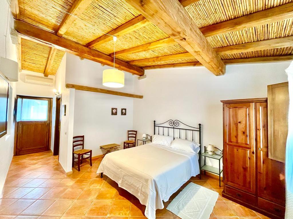 圣特奥多罗李司考匹乡村民宿的一间卧室设有一张床和木制天花板
