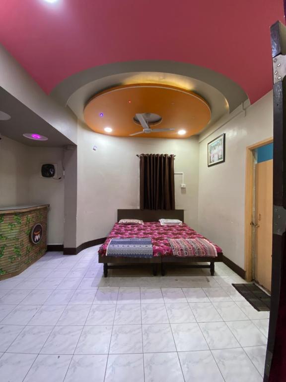 索拉普MUKTAI LODGE的一间带一张床铺的卧室,位于带天花板的房间内