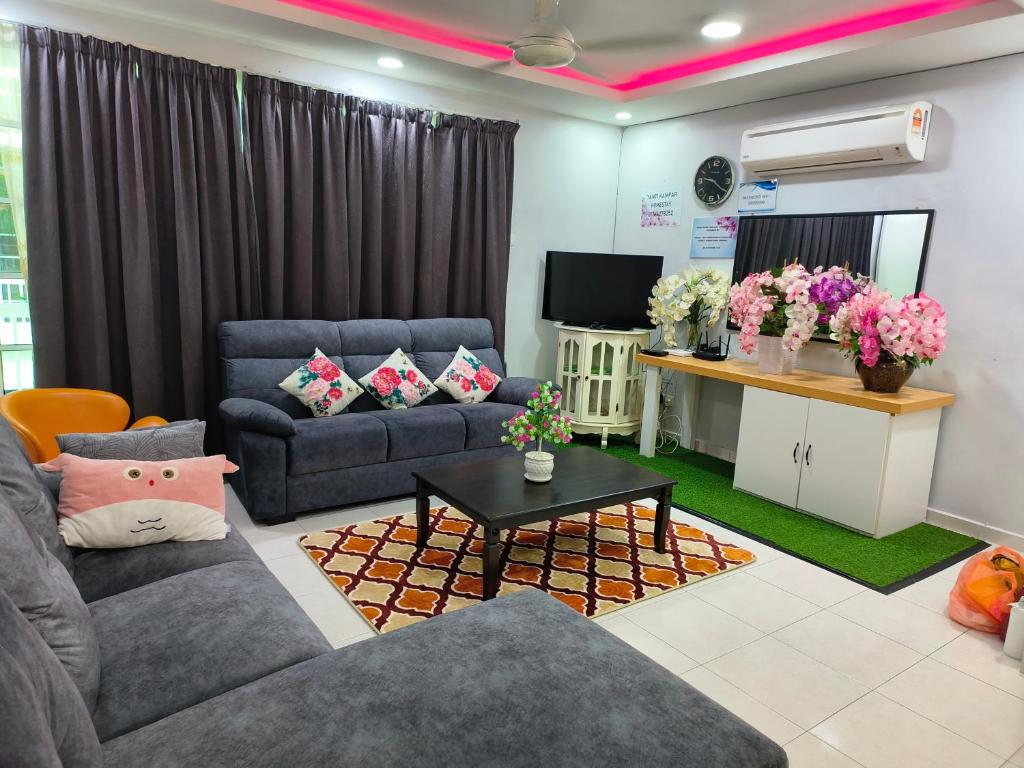 金宝Trails of Kampar Villa Homestay的客厅配有两张沙发和一台电视