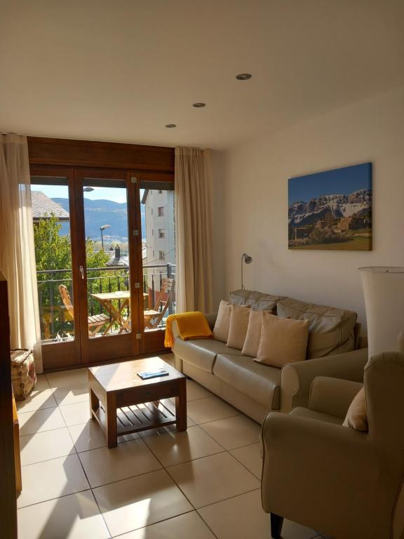 普奇塞达Apartaments Bell-Lloc Puigcerda的客厅配有沙发和桌子