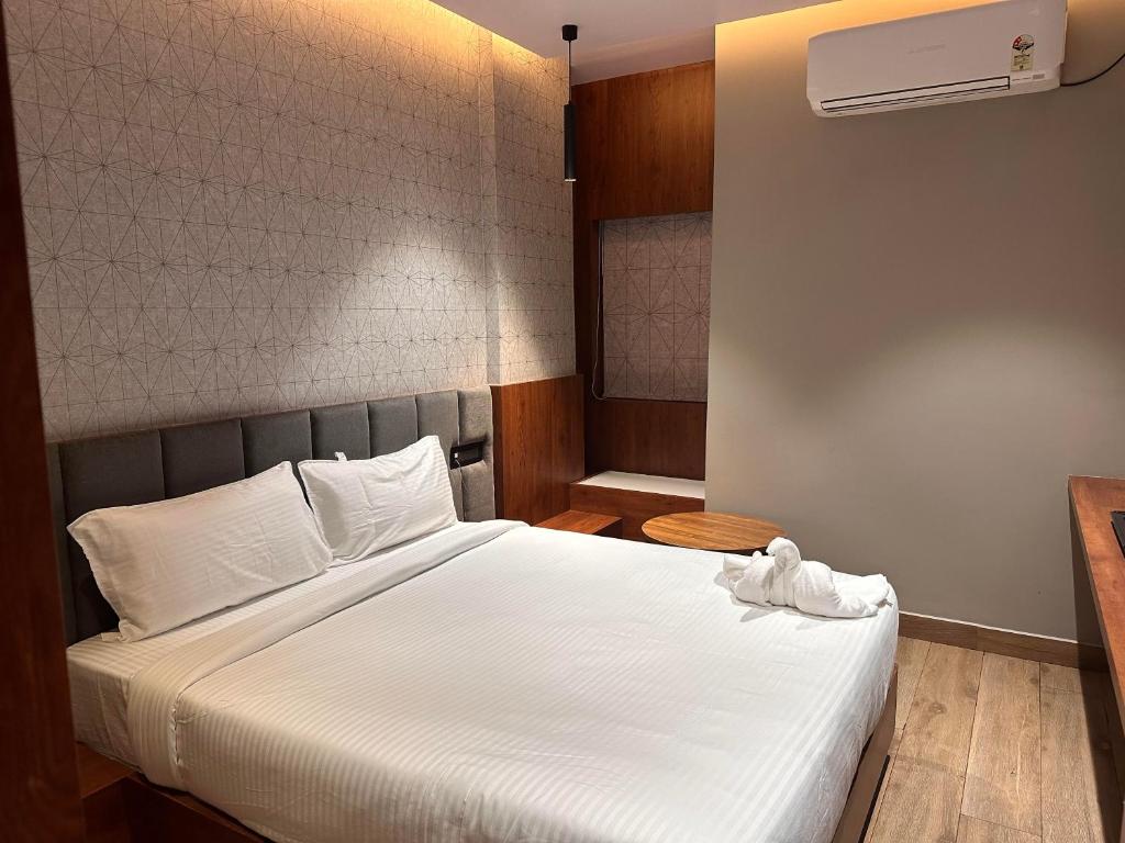 BrahmapurV HOTEL的卧室配有白色的床和空调