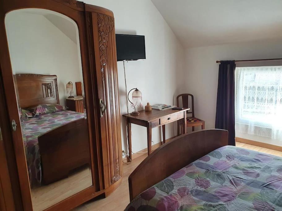 Logement 'la Hulotte'-10 min d'Auxerre-2h de Paris的一间卧室配有一张床、镜子和一张桌子