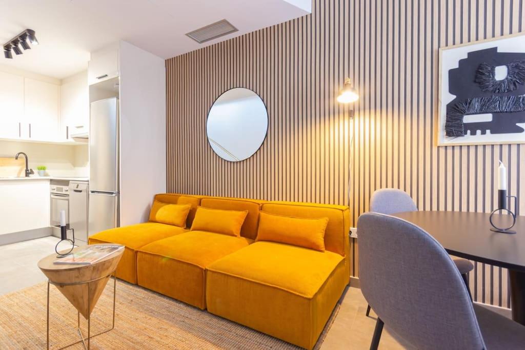 特拉萨Duplex with terrace near Bcn的客厅配有黄色的沙发和桌子