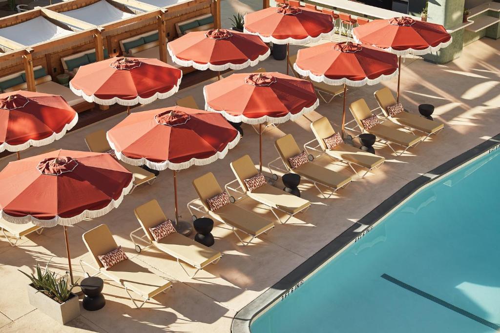 棕榈泉Life House, Palm Springs的游泳池旁的椅子和遮阳伞的顶部景色