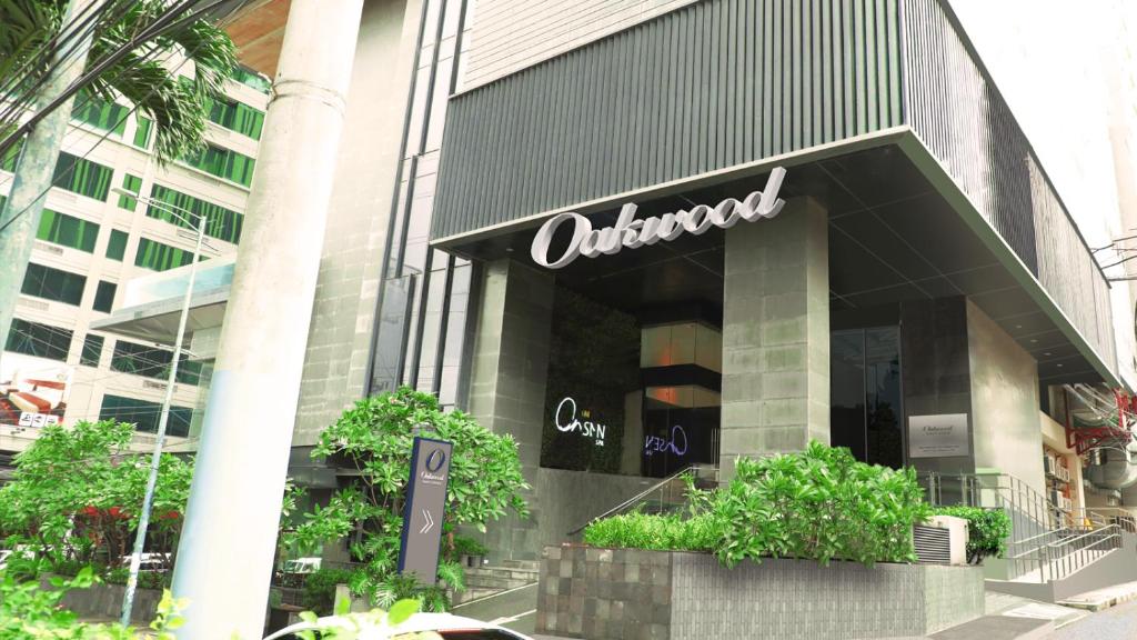 马尼拉Oakwood Makati Avenue的建筑物前方的统一标志