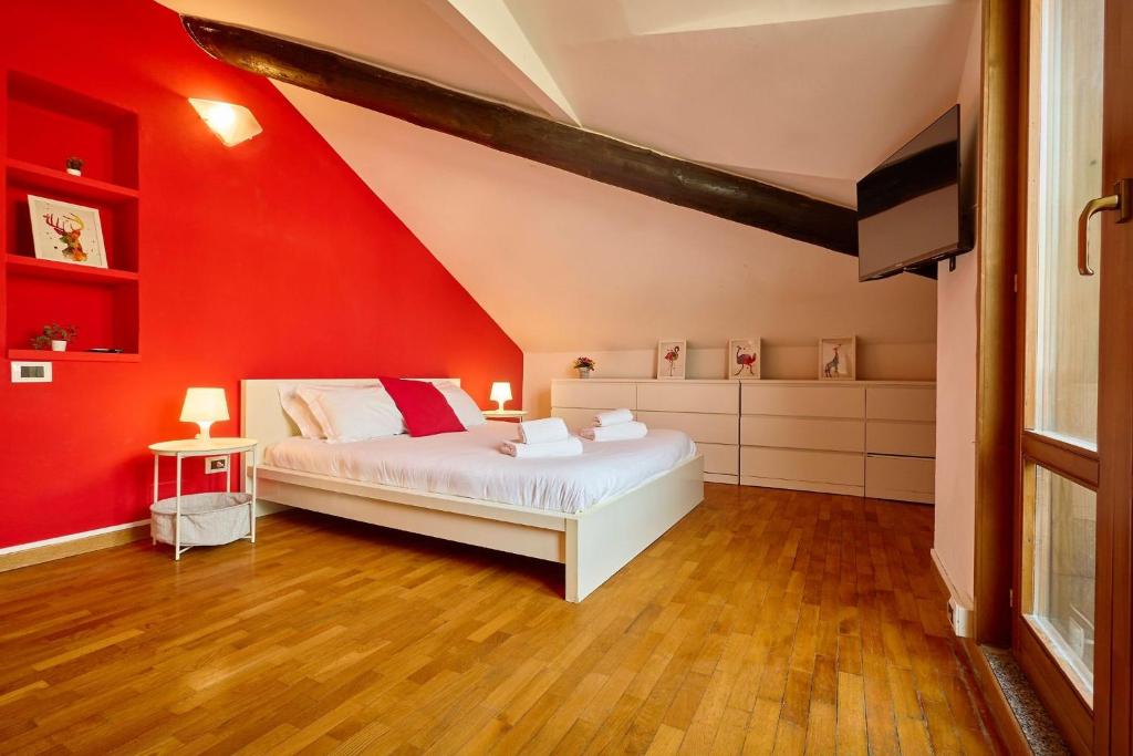 米兰Moscova Charme Apartment的卧室设有红色的墙壁和一张床