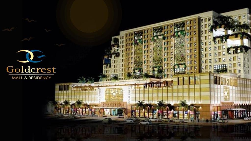 拉合尔One Bed Appartment in GoldCrest Mall and residency DHA Lahore的一座棕榈树环绕的大建筑