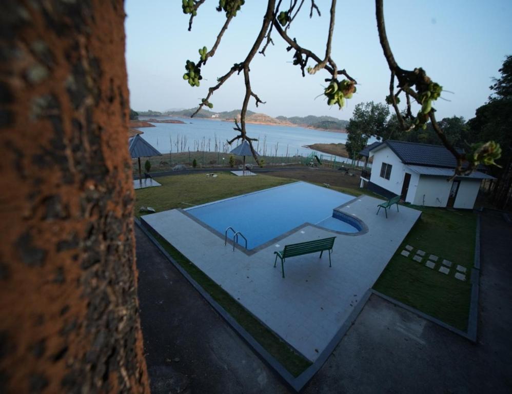 PadinjaratharaMisty Dam Wayanad Premium Resort With Banasura Dam View的游泳池顶部景色,设有长凳