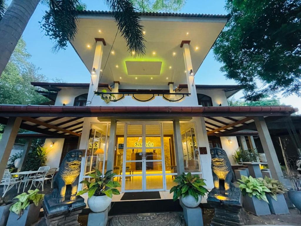 阿努拉德普勒Sadula Holiday Resort的一座黄色门的房子和一座建筑