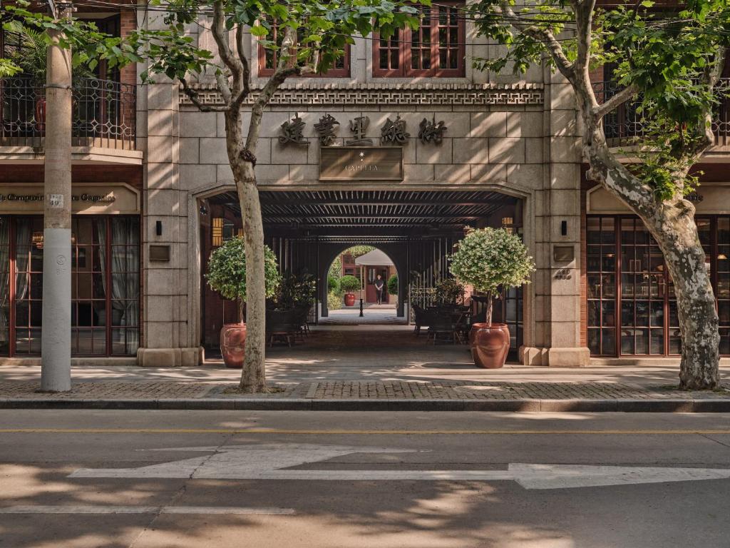 上海上海建业里嘉佩乐酒店的人行道上树木林立的建筑入口