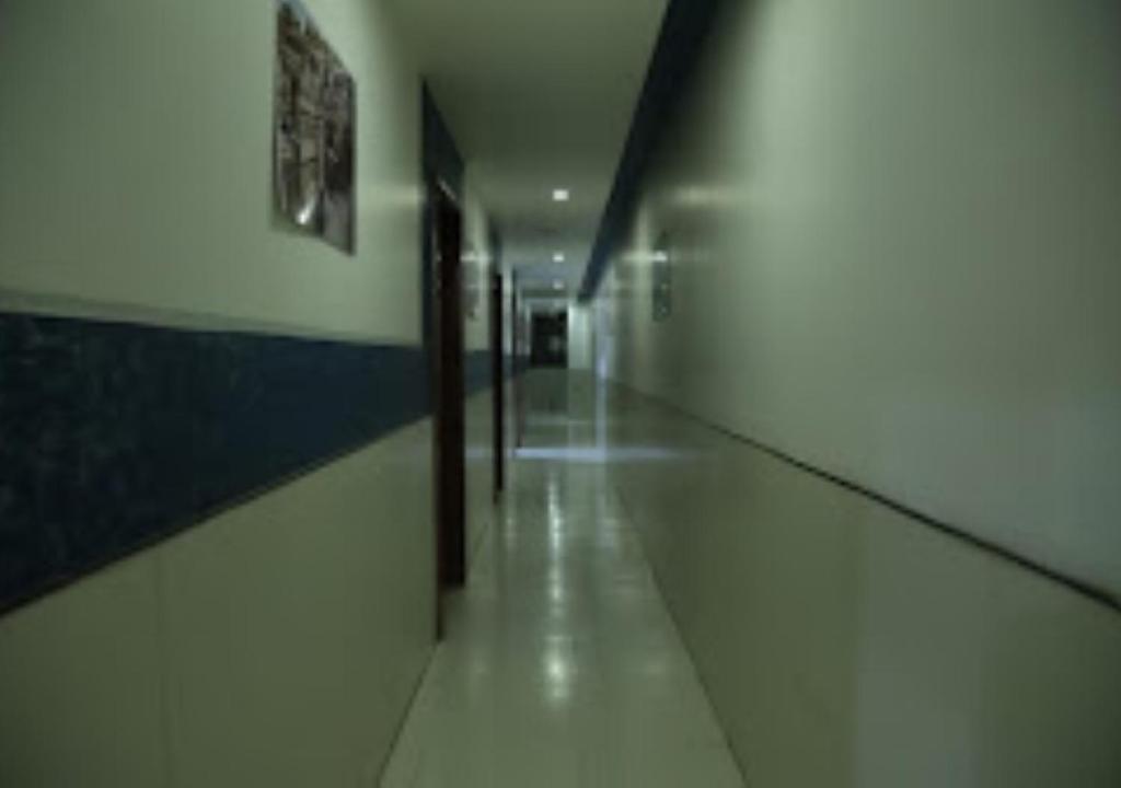 JālgaonHotel Kewal INN Jalgaon的走廊在建筑物里,有长长的走廊