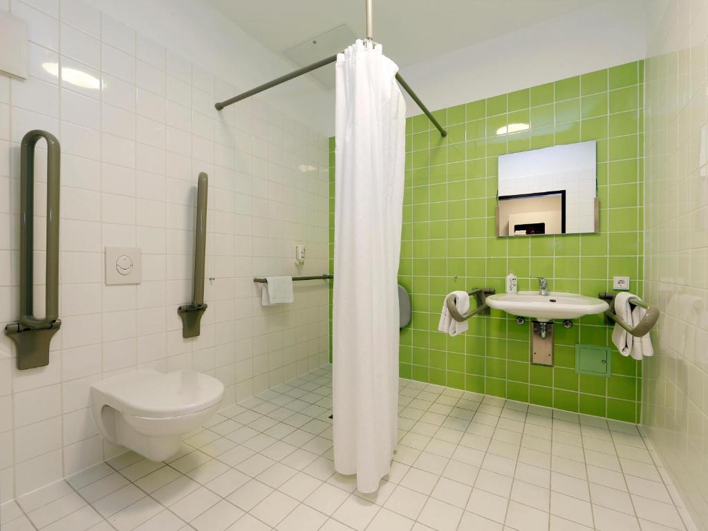 柏林柏林 - 蒂尔加滕酒店的绿色和白色的浴室设有卫生间和水槽