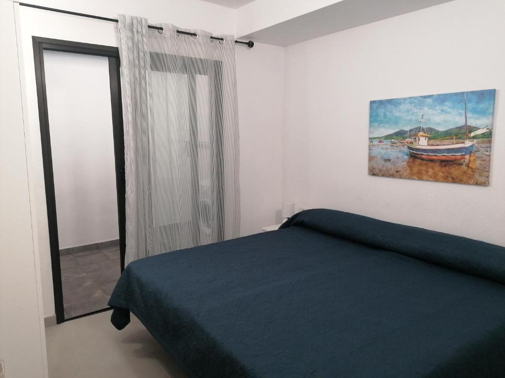 洛斯·亚诺斯·德·阿里丹Vivienda El Remo-Vv-3的卧室配有一张床,墙上挂有绘画作品