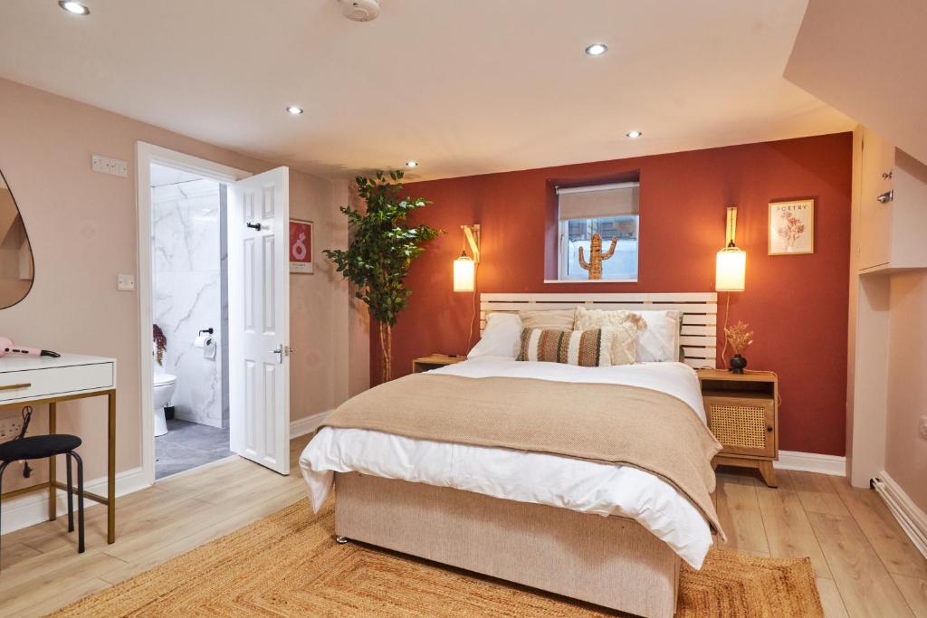 利兹Homebird Property - Haddon House的一间卧室配有一张带橙色墙壁的大床