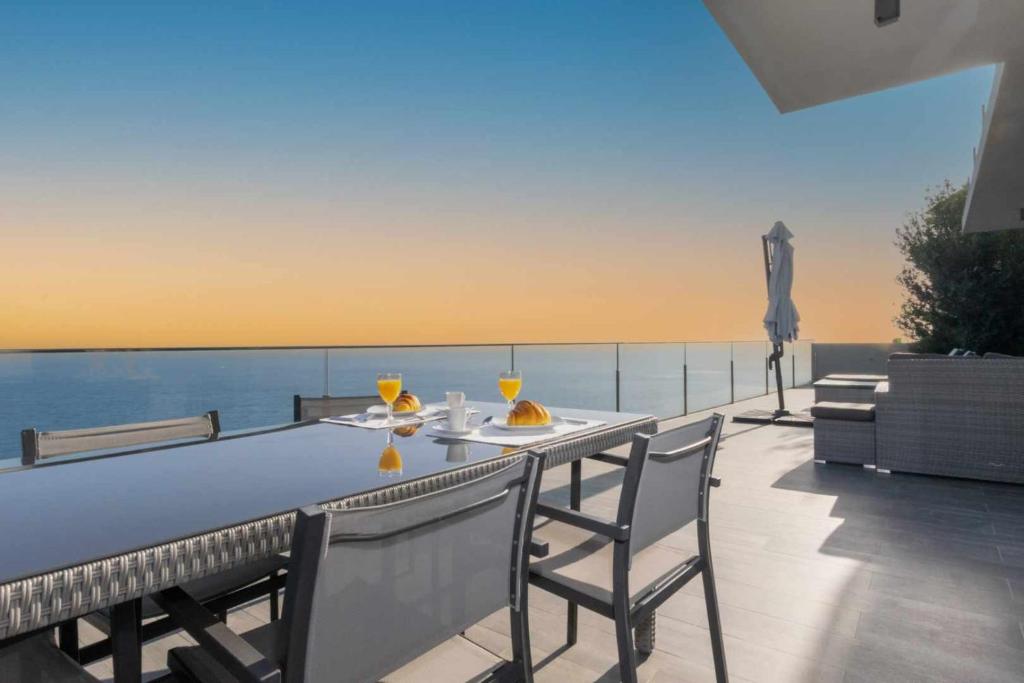 蓬他达维托亚Villa Harmonia by Place OverSea With Indoor Pool的海景阳台上的桌椅
