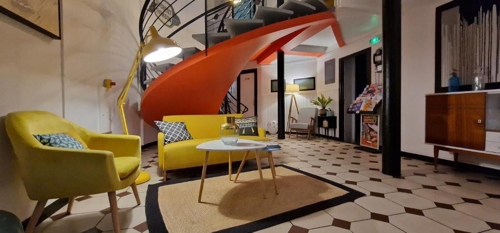 鲁瓦扬Hôtel La Croisette & Restaurant Bistrot Gantier的客厅配有黄色椅子和桌子
