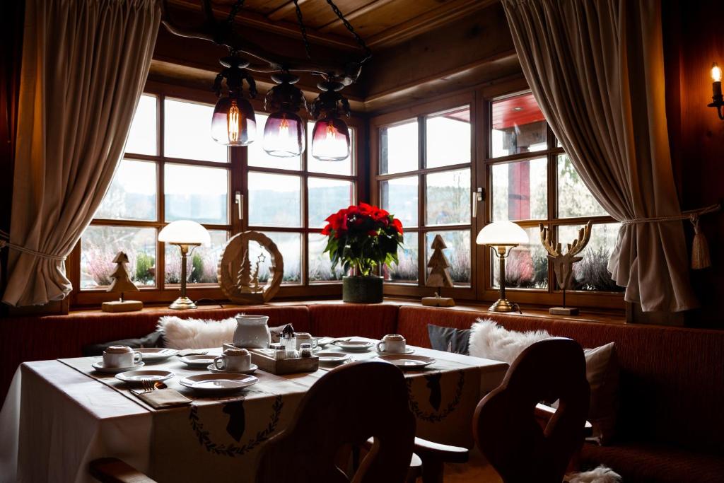蒂蒂湖-新城Hotel zum See, Titisee的一间带桌子和大窗户的用餐室