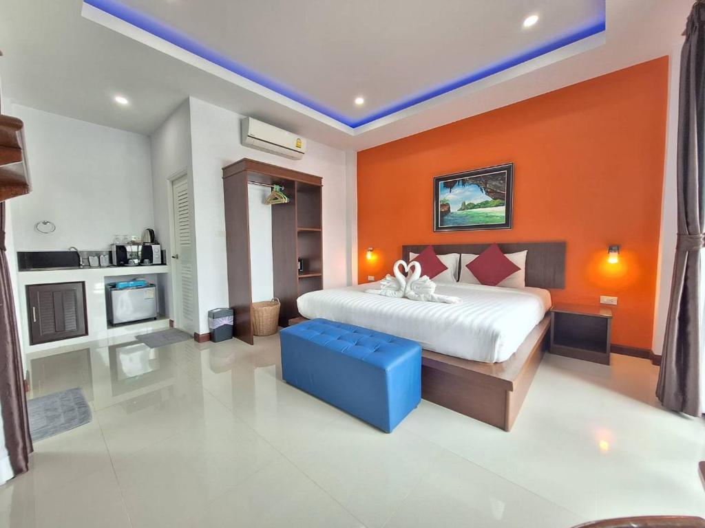 高兰兰达尊贵酒店的一间卧室配有一张带橙色墙壁的大床